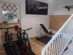 two bikes parked in a room with a staircase at Accommodation in the town center, on a private courtyard in CastellʼAlfero
