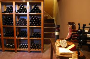 a room filled with lots of bottles of wine at El Castillo de Mandl in La Cumbre
