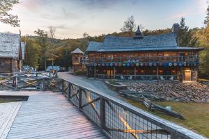a wooden bridge leading to a large building at Vikings Villages Resort in Guilford