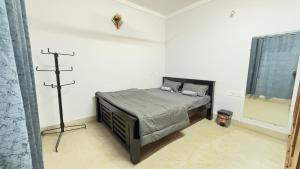 a bedroom with a bed and a cross on the wall at Casa Red Homestay in Chikmagalūr
