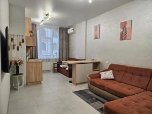 a living room with a couch and a table at Avinion 2 Апартаменты у моря in Odesa
