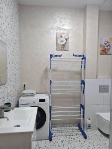 a washing machine in a bathroom with a sink at Avinion 2 Апартаменты у моря in Odesa +9 photos