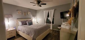 a bedroom with a bed and a ceiling fan at Jenkins Cove Getaway in Tybee Island