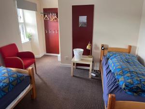 a bedroom with a bed and a chair and a table at Tobermory Youth Hostel in Tobermory