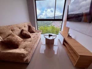 a living room with a couch and a large window at Nuevo apartamento moderno, espectacular vista in Manizales
