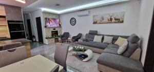 a living room with a couch and a fireplace at Noszvaj Vendégház in Noszvaj