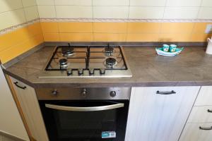 a stove top oven in a kitchen with yellow tiles at Well in House Casa Vacanze in Cetara