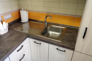 a stainless steel sink in a small kitchen at Well in House Casa Vacanze in Cetara