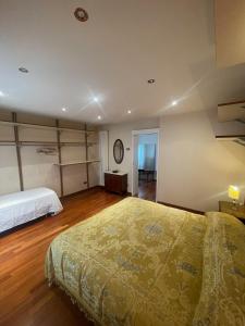 a bedroom with a large bed and wooden floors at Villa Adele Città Sant'Angelo in Citta' Sant'Angelo