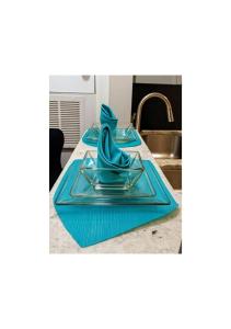 a table with three blue plates on it at The Serene Uptown Flat in Charlotte