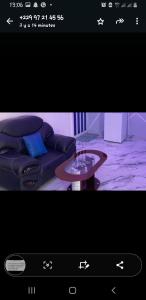 a living room with a couch and a coffee table at HÔTEL & RÉSIDENCE KoB in Agbato