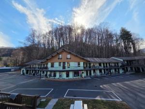 a large building with a tennis court in a parking lot at Castlewood Inn in Maggie Valley +19 photos