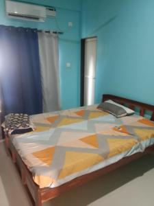 a bedroom with a bed with a colorful comforter at Casa De D'souza in Mandrem