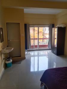 a bedroom with a bed and a sink and a window at Casa De D'souza in Mandrem +7 photos