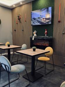 a restaurant with two tables and a tv on the wall at B&B Cvjetni in Zagreb