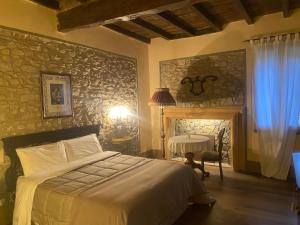 a bedroom with a bed and a table and a window at BORGO VILLA VALENTINI in Scandiano