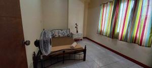a living room with a fan in a room at Domizil Suites in Batangas City