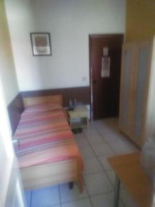 a room with a bed and a table and a door at La Locanda del Re in Crevalcore