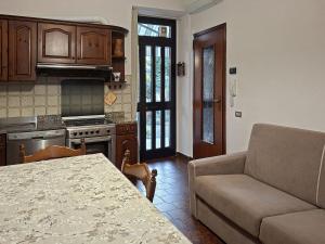 a kitchen with a couch and a table in a room at La Corte dei Nonni in Vanzaghello