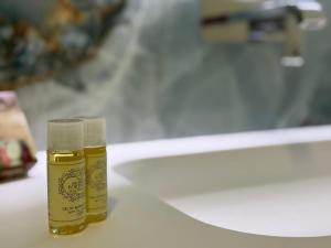 two bottles of oil sitting on a bathroom counter at Calcedonia House - Gerês in Terras de Bouro +20 photos