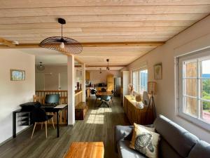 a living room with a couch and a table at Gîtes BEL'M in La Bresse