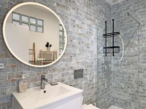 a bathroom with a white sink and a mirror at Casa Alice - Olhão By Junto ao Mar in Olhão