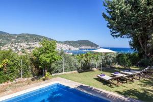 a villa with a swimming pool and a view of the ocean at Μeropi & Natalia Villas in Skopelos Town