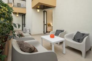 a patio with chairs and a table and a table at Baía II by An Island Apart in Funchal