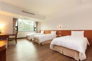 Postel nebo postele na pokoji v ubytování F Hotel - Chiayi + 37 fotografií