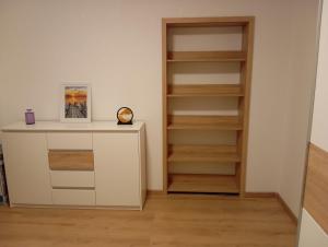 a room with a book shelf and a white cabinet at Apartmaji Divji vrt in Lendava