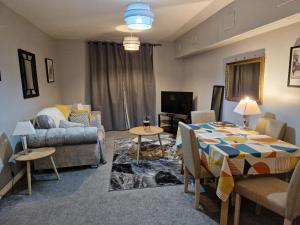 a living room with a table and a couch at Home Sweet Home, Calverley Court Apartment Home in West Midlands, England in Parkside +5 photos