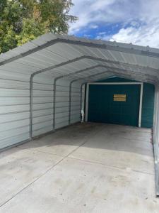 a garage with a green door with a sign on it at 855 N Grant Ave in Loveland