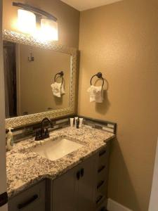a bathroom with a sink and a mirror at 855 N Grant Ave in Loveland