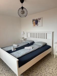 a bedroom with a large white bed with blue sheets at Finca Rosa in Güimar