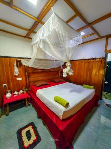 a bedroom with a large bed with a canopy at Maika safari lodge in Udawalawe +89 photos