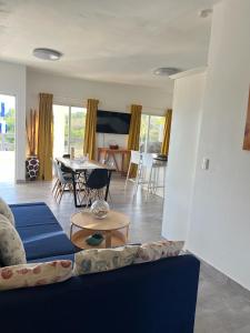 a living room with a blue couch and a table at Apartamento Carey in Cabrera