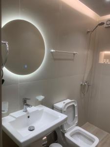 a bathroom with a sink and a toilet and a mirror at Manga guesthouse in Gjirokastër +36 photos