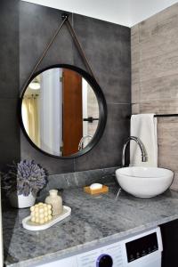 a bathroom with a sink and a mirror at Apart Altos de Ensueño in La Falda +34 photos