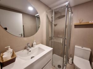 a bathroom with a sink and a shower with a mirror at Hikary in Lavra