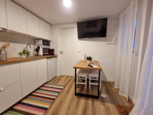 a kitchen with a wooden table and a small desk at Hikary in Lavra