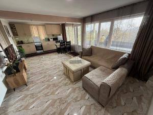 a living room with a couch and a table at Ortachala Valley Retreat in Sighnaghi