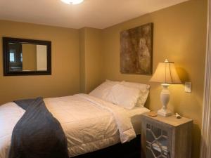 a bedroom with a bed and a lamp on a table at 855 N Grant Ave in Loveland