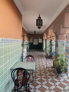a room with a table and chairs on a tile floor at APPART AIGLE HOTEL in Ouarzazate