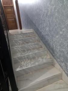 a set of stairs in a room with blue wallpaper at Femi in Dakar +3 photos