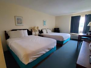 Ένα ή περισσότερα κρεβάτια σε δωμάτιο στο Voyager Inn
