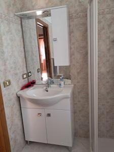 a bathroom with a white sink and a mirror at Casa della Nonna in Celledizzo