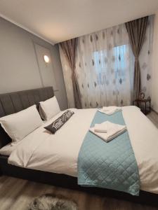 a bedroom with a bed with a remote control on it at Apartment Premium in Topliţa +15 photos