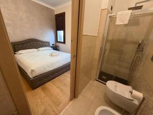 a bathroom with a bed and a shower and a toilet at Le Stanze Del Duca in Ferrara