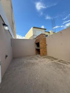 a parking lot with a brick fireplace in a building at Sendero Patagonico in Las Grutas