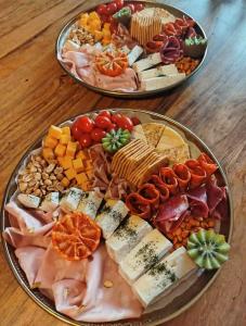 two plates of different types of food on a table at Domaine des Pins La cabane au bord de l'eau 